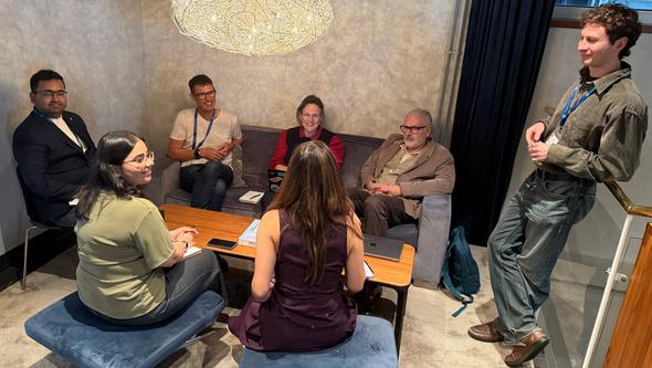 Doctoral candidates and supervisors discussing upcoming international secondments and collaboration projects between academic, c