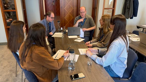 Small group discussions focused on planning secondments and defining concrete collaboration activities across disciplines and se